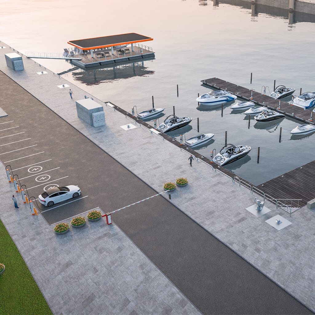 A waterfront marina with multiple boats docked along the pier. A car is parked next to the boat ramp, and a small building with a flat roof is on the water. The area is deserted and serene.